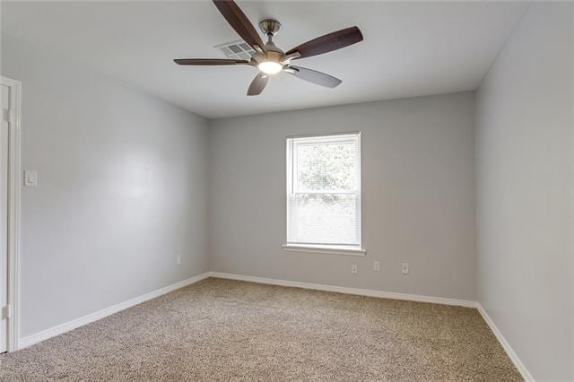 carpeted spare room featuring ceiling fan