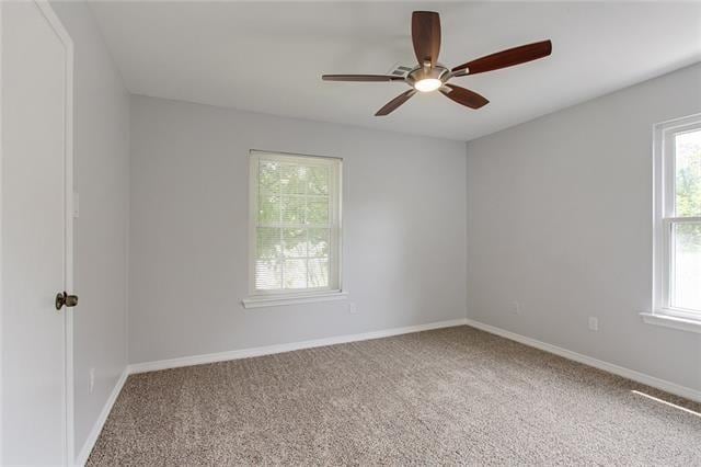 spare room with carpet, ceiling fan, and a healthy amount of sunlight