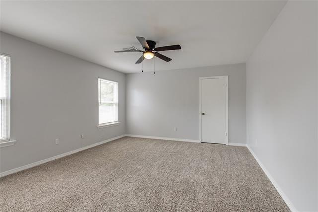 spare room featuring ceiling fan and carpet