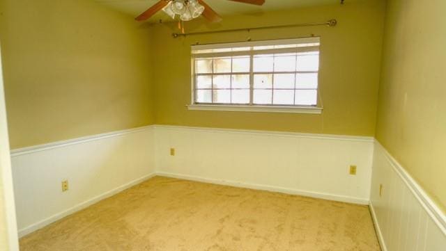 spare room featuring carpet floors and ceiling fan