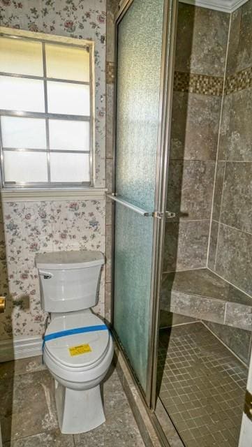 full bathroom featuring baseboards, a stall shower, toilet, and wallpapered walls