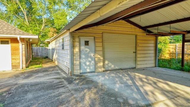 view of outbuilding with fence