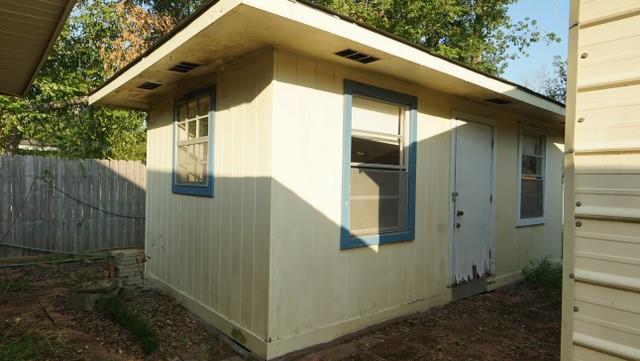 view of side of property featuring fence