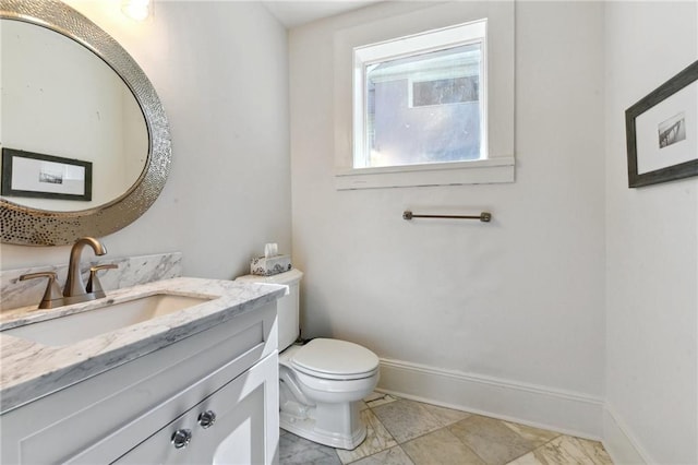 bathroom featuring tile patterned flooring, toilet, and vanity