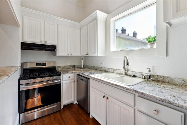 kitchen featuring sink, dark wood-type flooring, light stone countertops, white cabinetry, and stainless steel appliances