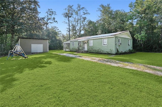 view of yard with a shed and a playground