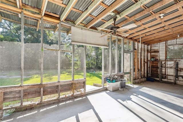 unfurnished sunroom featuring ceiling fan