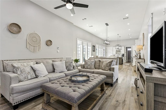 living room featuring ceiling fan and light hardwood / wood-style flooring