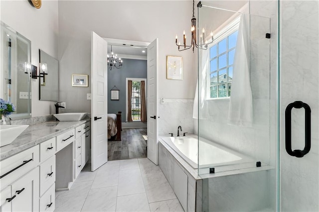 bathroom featuring crown molding, hardwood / wood-style floors, an inviting chandelier, and vanity