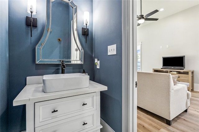 bathroom with ceiling fan, vanity, and hardwood / wood-style floors