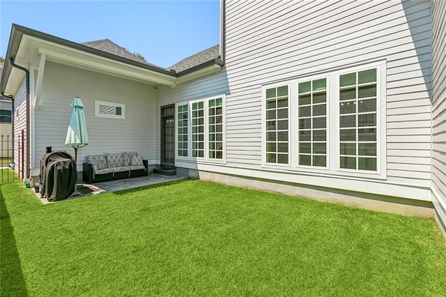 rear view of house featuring a patio area, a yard, and an outdoor hangout area