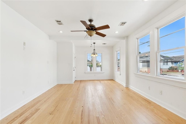 empty room featuring light wood-type flooring and ceiling fan