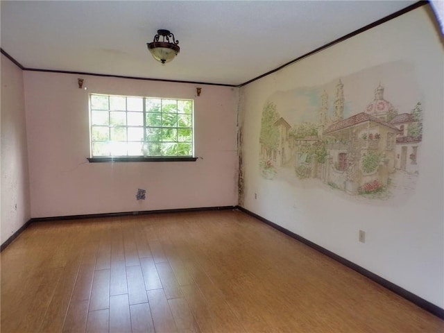 empty room featuring light hardwood / wood-style flooring and crown molding