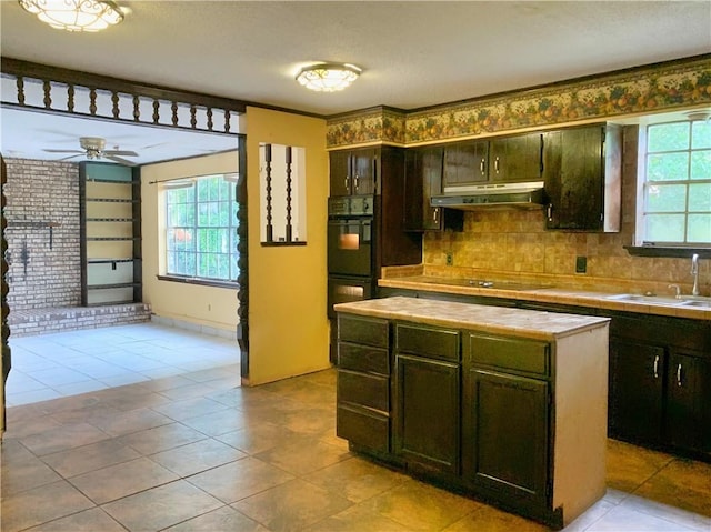 kitchen with backsplash, ceiling fan, light tile patterned flooring, and black appliances