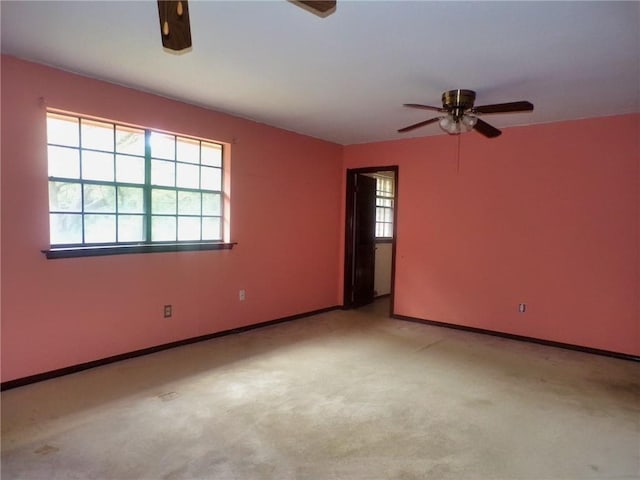 carpeted spare room featuring ceiling fan