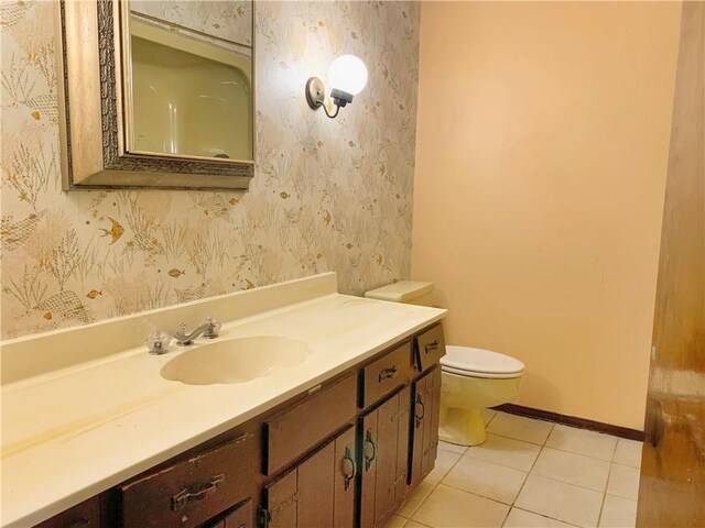 bathroom featuring tile patterned flooring, vanity, and toilet