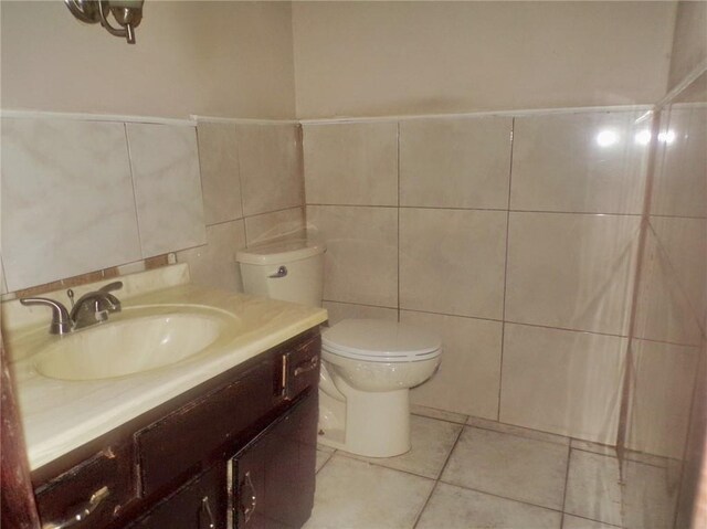 bathroom featuring tile walls, tile patterned flooring, vanity, and toilet