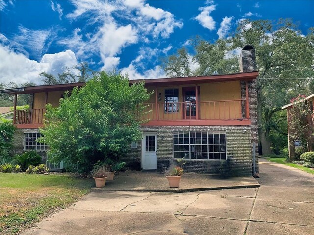 back of property featuring a balcony