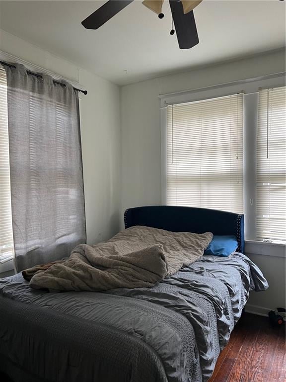 bedroom with ceiling fan and wood-type flooring