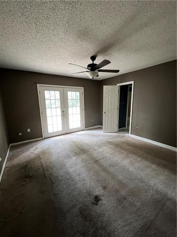 unfurnished bedroom with a textured ceiling, ceiling fan, carpet floors, and french doors