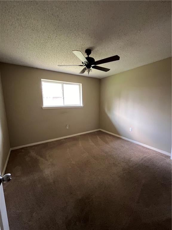 spare room with ceiling fan, carpet, and a textured ceiling