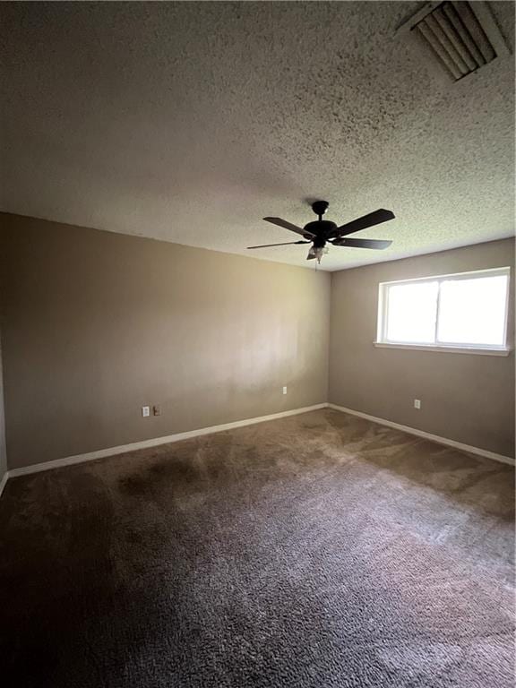 empty room featuring a textured ceiling, ceiling fan, and carpet floors