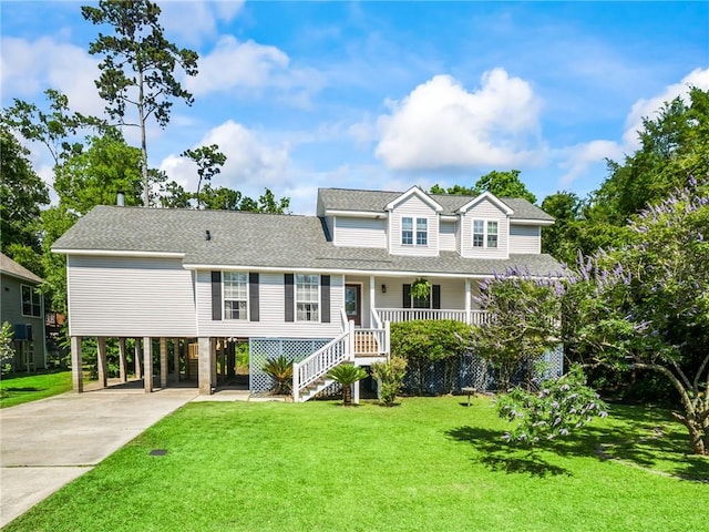 view of front of home with covered porch, a carport, and a front yard