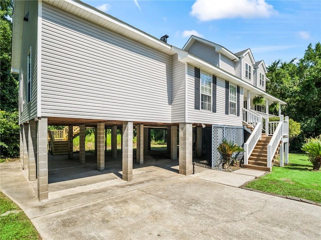 view of side of property with a porch and a carport