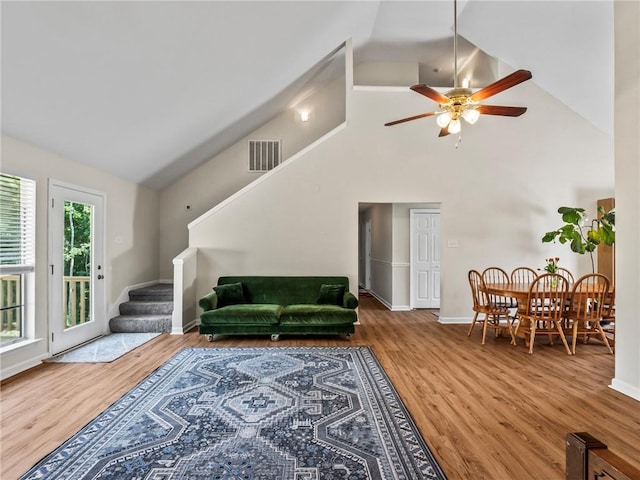 living room featuring hardwood / wood-style flooring, high vaulted ceiling, and ceiling fan