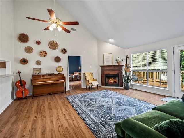 living room with high vaulted ceiling, wood-type flooring, and ceiling fan