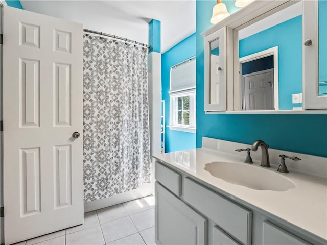 bathroom featuring vanity, tile patterned floors, and curtained shower