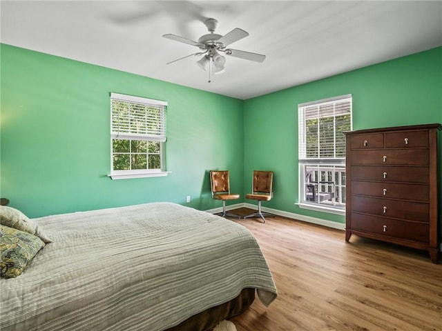 bedroom with light hardwood / wood-style flooring and ceiling fan