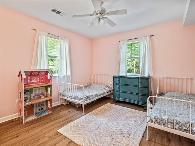 bedroom featuring wood-type flooring and ceiling fan