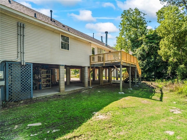 rear view of house with a patio, a deck, and a lawn