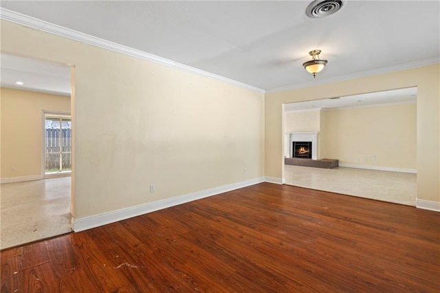 unfurnished living room with crown molding, hardwood / wood-style floors, and a brick fireplace