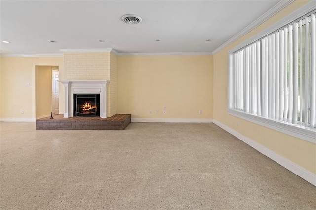 unfurnished living room with a fireplace, crown molding, and brick wall