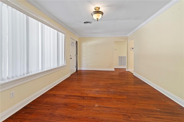 empty room with hardwood / wood-style floors and ornamental molding