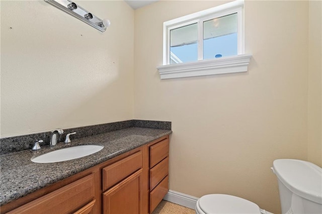 bathroom featuring toilet and vanity