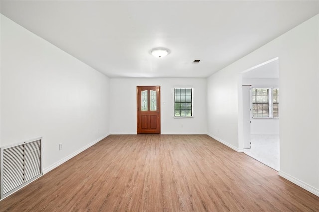 entryway with light hardwood / wood-style flooring and a healthy amount of sunlight