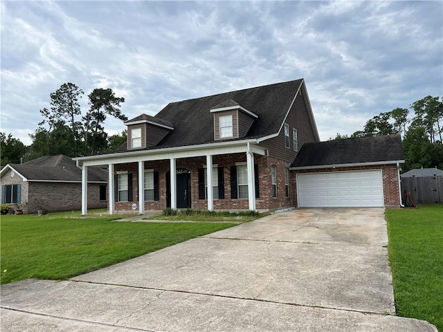 view of front of property with covered porch, a front yard, concrete driveway, and brick siding