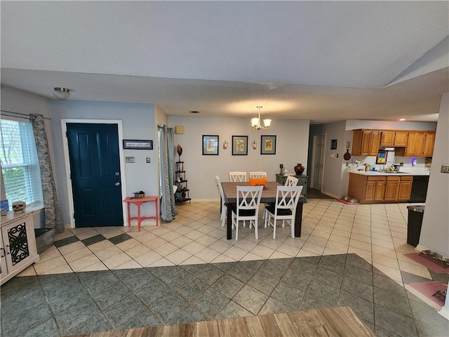 dining space featuring a notable chandelier and light tile patterned floors