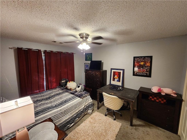 bedroom with a textured ceiling, ceiling fan, and light colored carpet