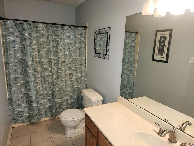 bathroom featuring curtained shower, vanity, toilet, and tile patterned floors