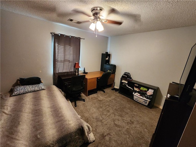 carpeted bedroom featuring ceiling fan and a textured ceiling