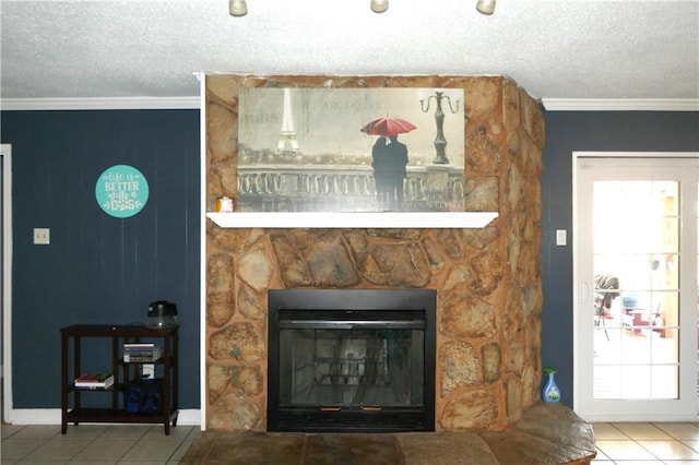 room details with a textured ceiling, ornamental molding, a fireplace, and baseboards