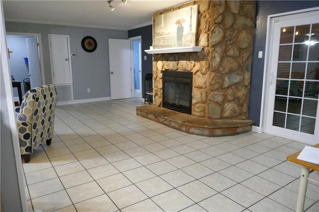 unfurnished living room featuring light tile patterned floors, ornamental molding, a fireplace, and baseboards