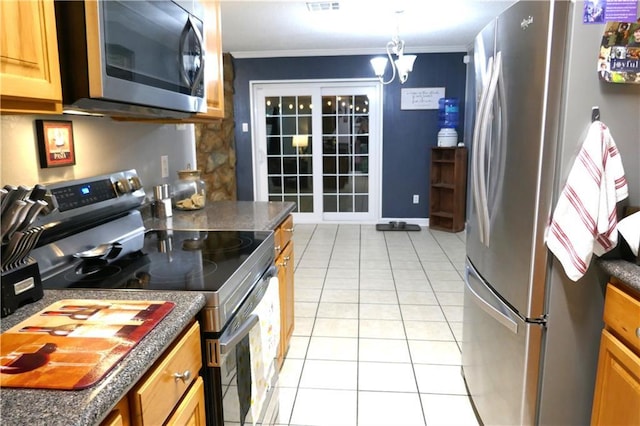 kitchen with light tile patterned floors, stainless steel appliances, dark countertops, brown cabinetry, and ornamental molding