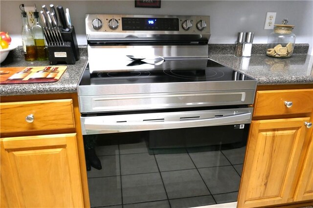 kitchen featuring stainless steel electric stove and range hood