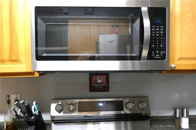 interior details with light tile patterned floors, sink, and dishwasher