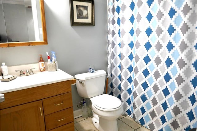 full bathroom featuring toilet, vanity, and tile patterned floors